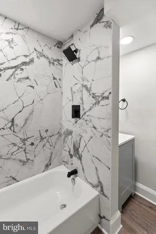 a bathroom with a bathtub and shower