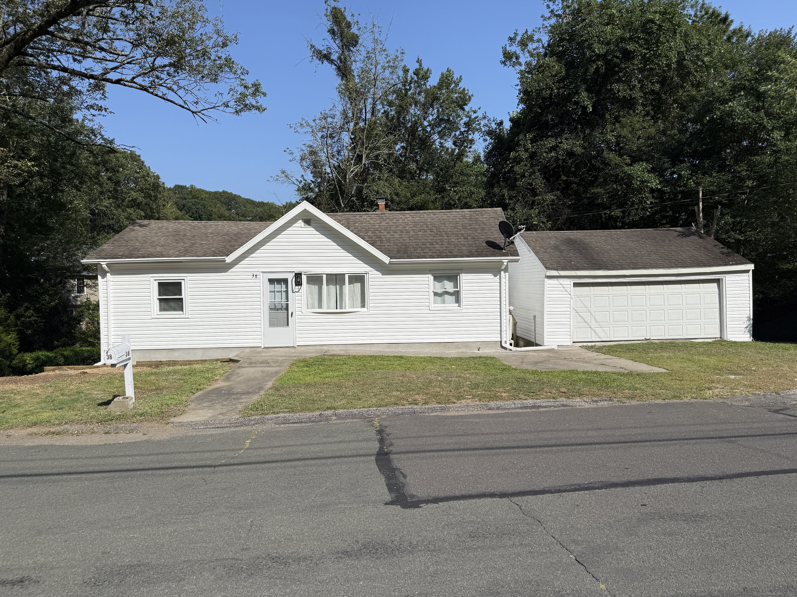 a view of house with outdoor space and sitting area