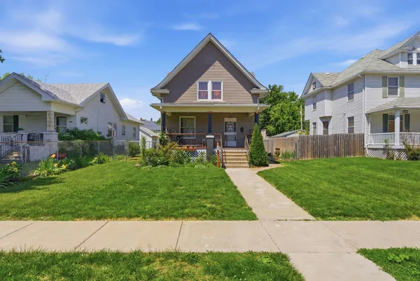 a front view of house with yard and green space