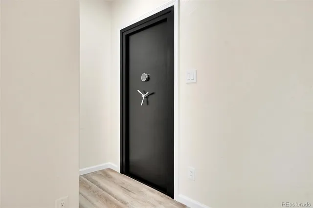 a spacious bedroom with a bed and a potted plant