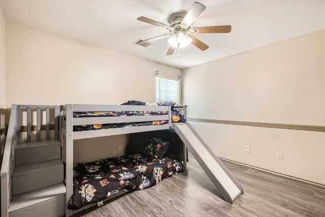 a bathroom with a granite countertop sink toilet and a mirror