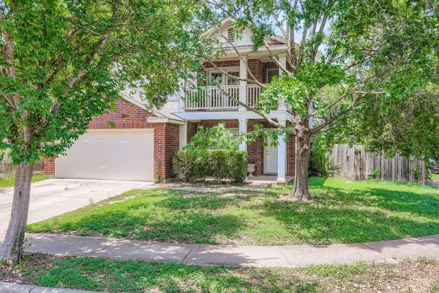 a front view of house with a garden