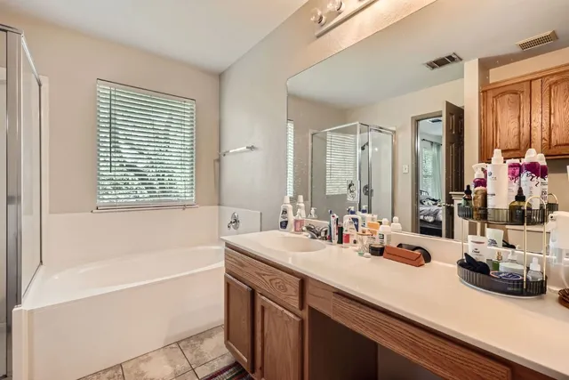a view of a backyard with table and chairs and a barbeque