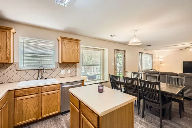 a bathroom with a tub sink and mirror