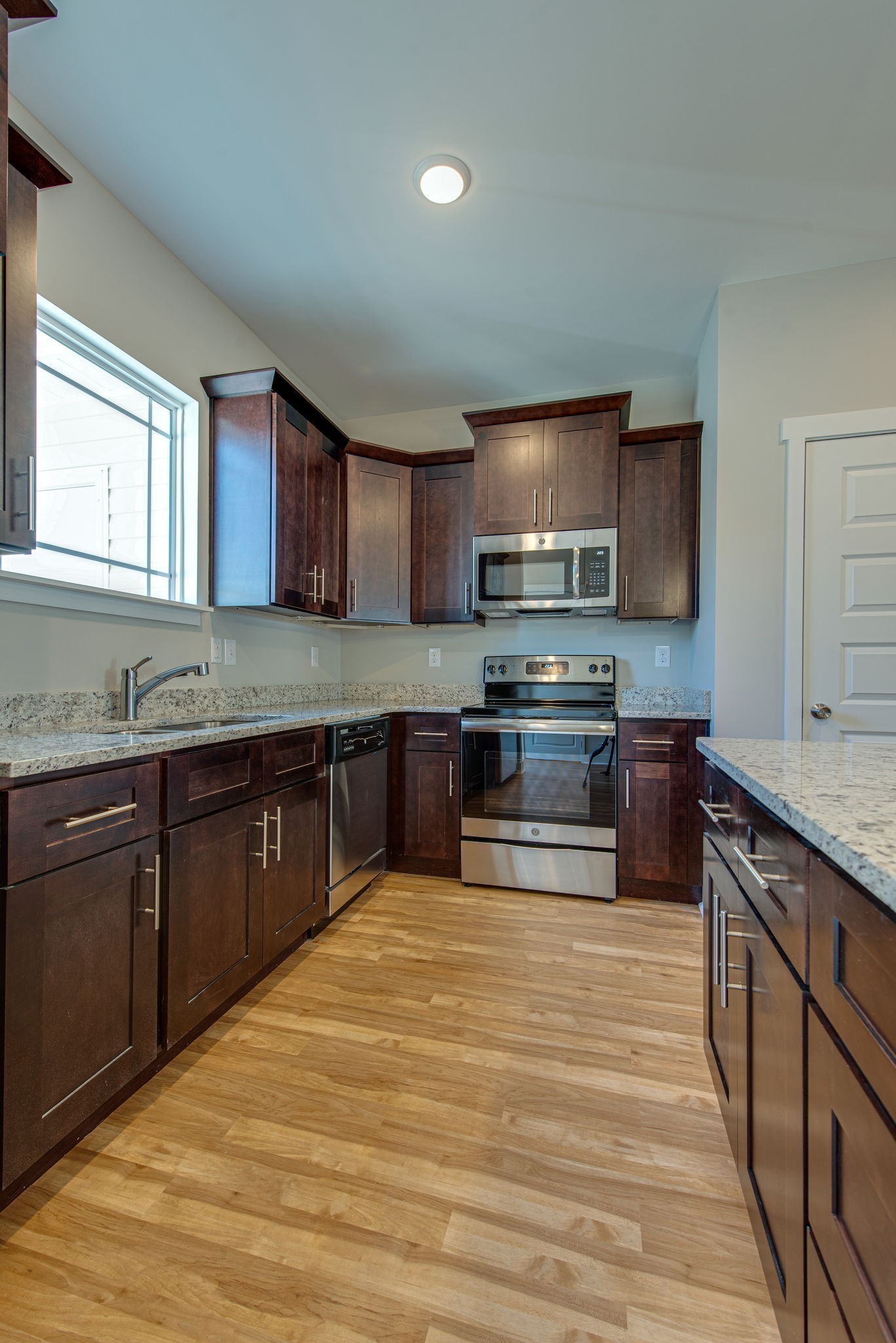 3010 Coriander Dr Spring Hill Spring Hill, TN 37174 - Photo 12 of 37 a kitchen with stainless steel appliances granite countertop a sink stove and microwave