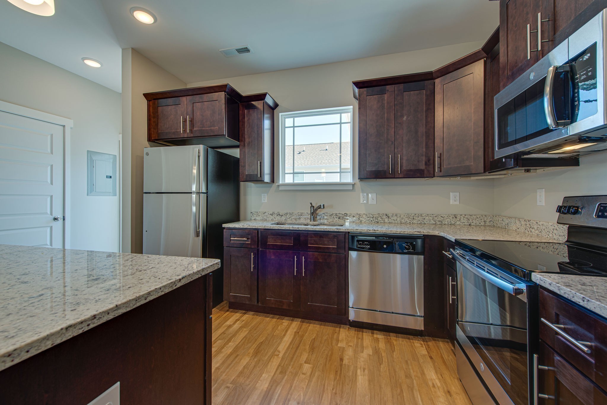 3010 Coriander Dr Spring Hill Spring Hill, TN 37174 - Photo 13 of 37 a kitchen with refrigerator cabinets and wooden floor