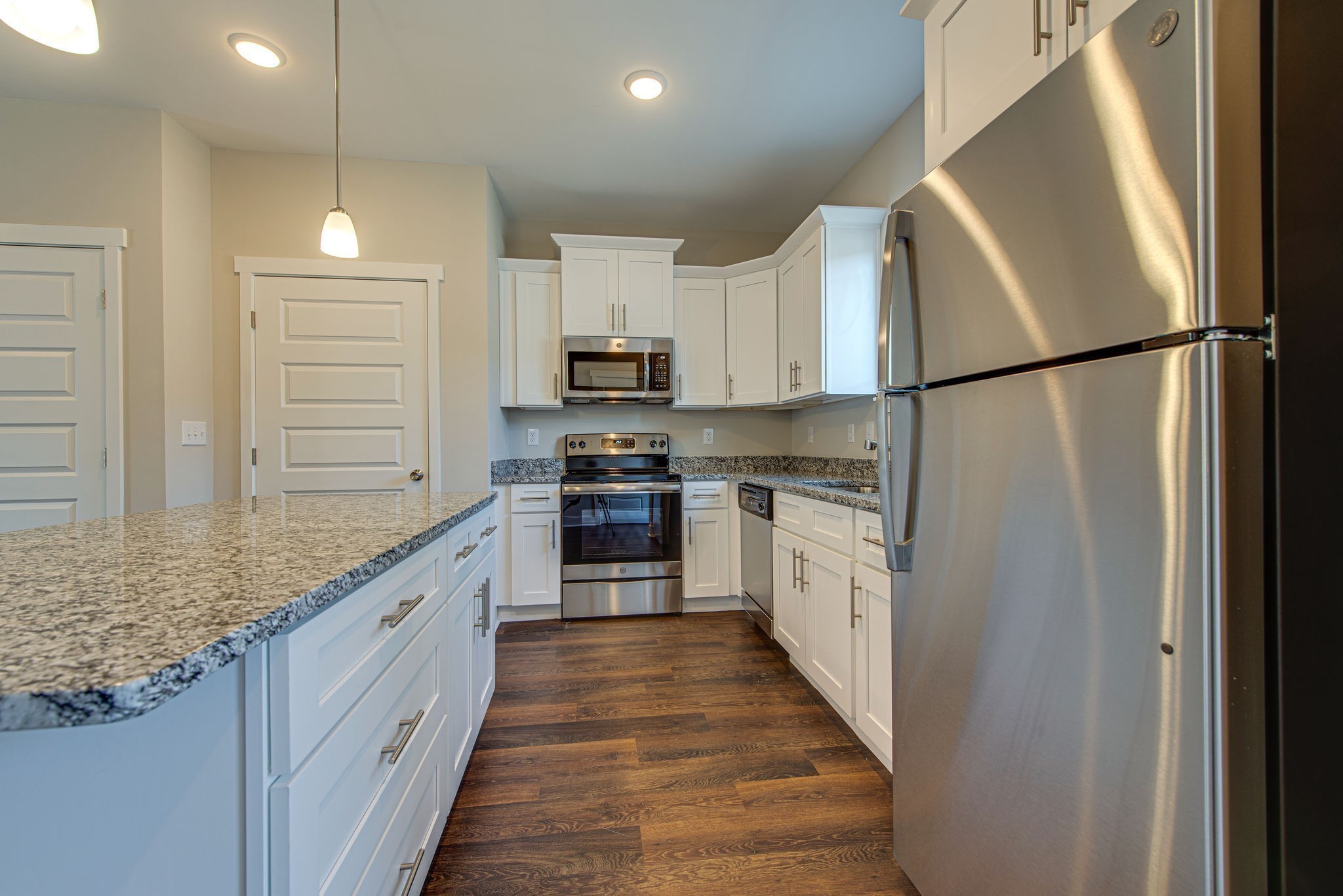3010 Coriander Dr Spring Hill Spring Hill, TN 37174 - Photo 21 of 37 a large kitchen with white cabinets and stainless steel appliances