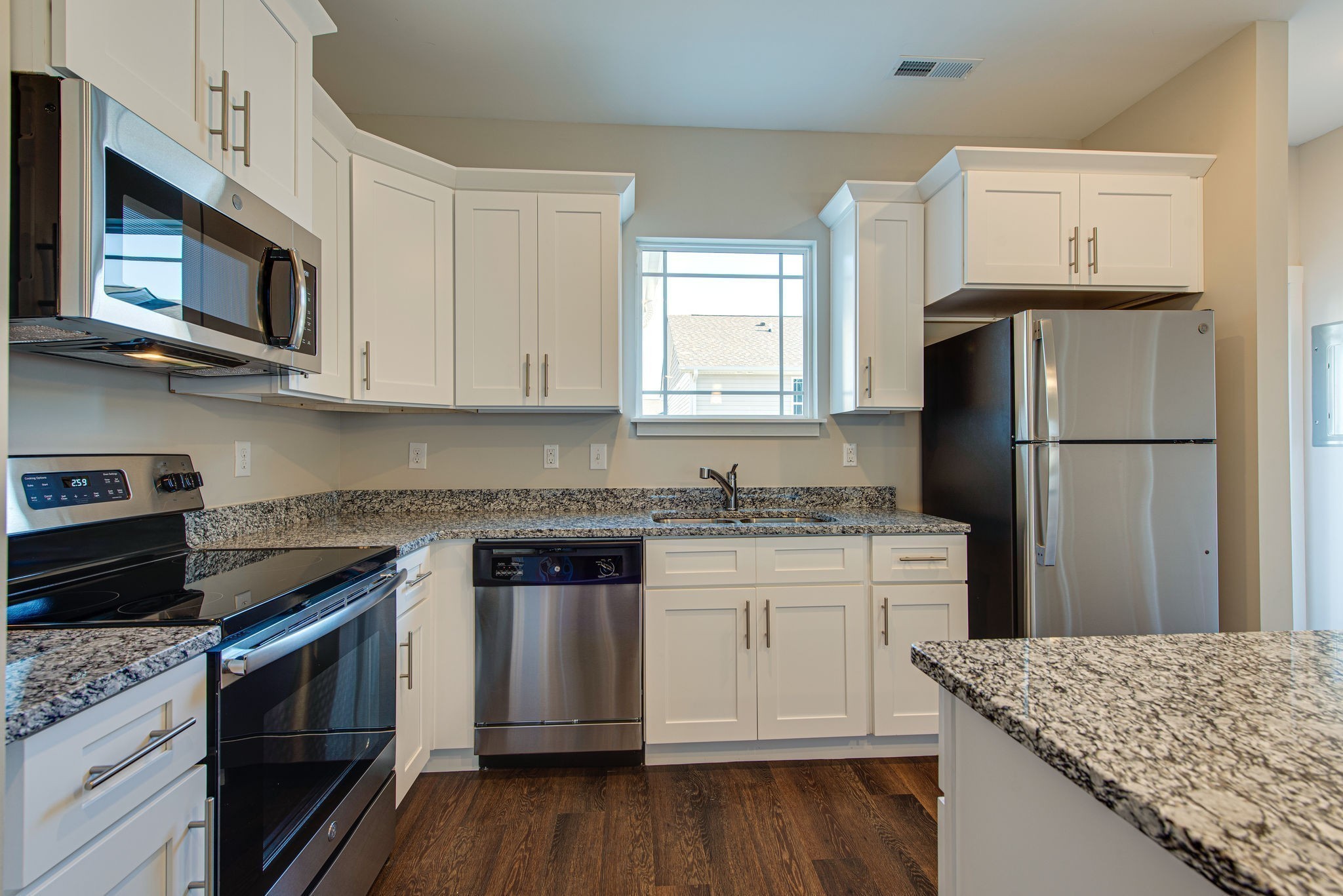 3010 Coriander Dr Spring Hill Spring Hill, TN 37174 - Photo 22 of 37 a kitchen with stainless steel appliances granite countertop a stove top oven microwave and refrigerator