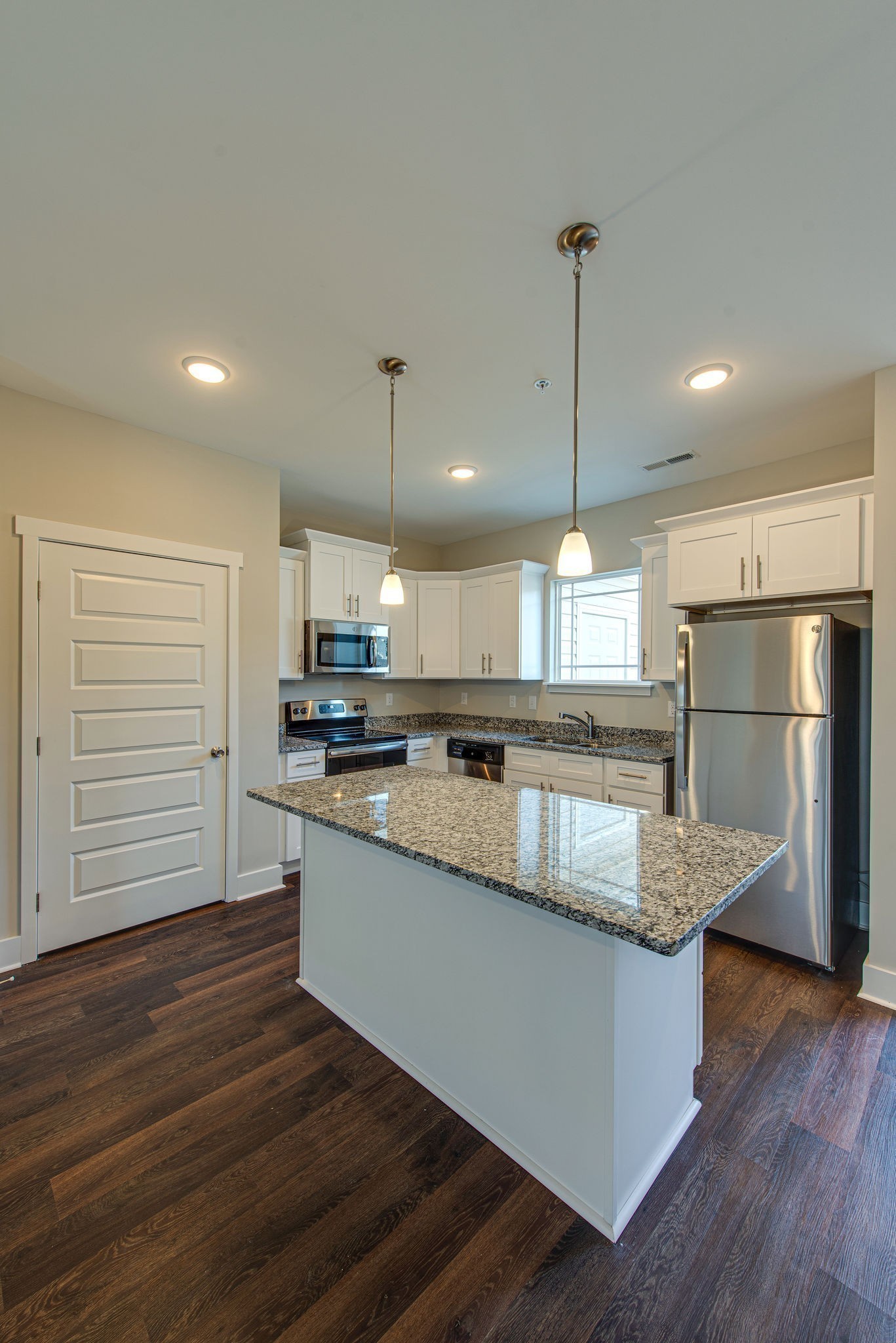 3010 Coriander Dr Spring Hill Spring Hill, TN 37174 - Photo 23 of 37 a kitchen with stainless steel appliances granite countertop a refrigerator a sink dishwasher a stove and a wooden floor