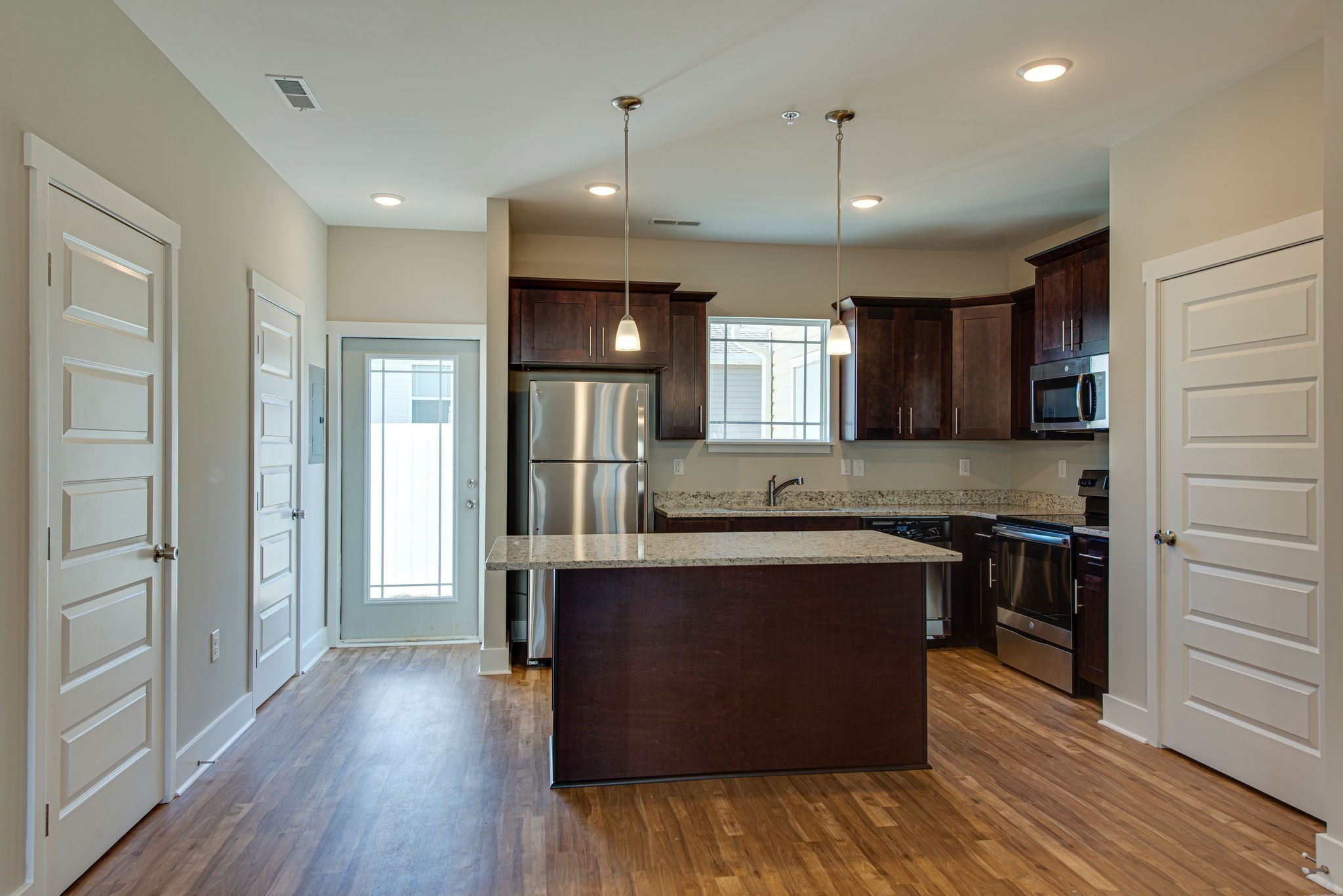 3010 Coriander Dr Spring Hill Spring Hill, TN 37174 - Photo 9 of 37 a large kitchen with stainless steel appliances granite countertop a stove and a wooden floors