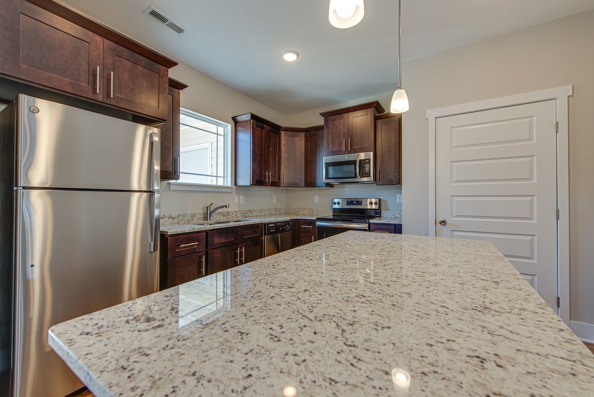 3010 Coriander Dr Spring Hill Spring Hill, TN 37174 - Photo 10 of 37 a kitchen with stainless steel appliances granite countertop a refrigerator sink stove and microwave