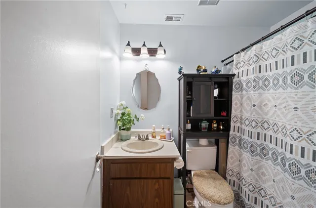 a bathroom with a sink toilet and mirror
