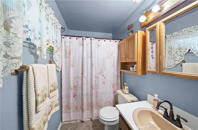 a white toilet sitting next to a bathroom sink