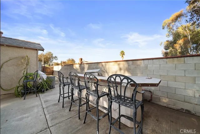 a view of a chairs and table in patio