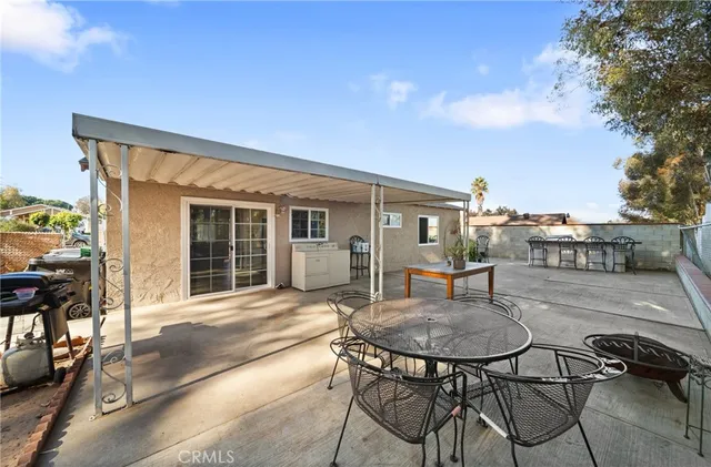 a backyard of a house with table and chairs