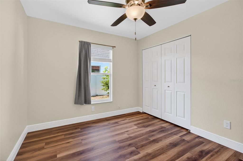 2174 19th Avenue Southwest Largo, FL 33774 - Photo 16 of 31 a view of an empty room with wooden floor and a window