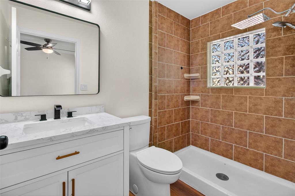 2174 19th Avenue Southwest Largo, FL 33774 - Photo 23 of 31 a bathroom with a sink mirror toilet and shower