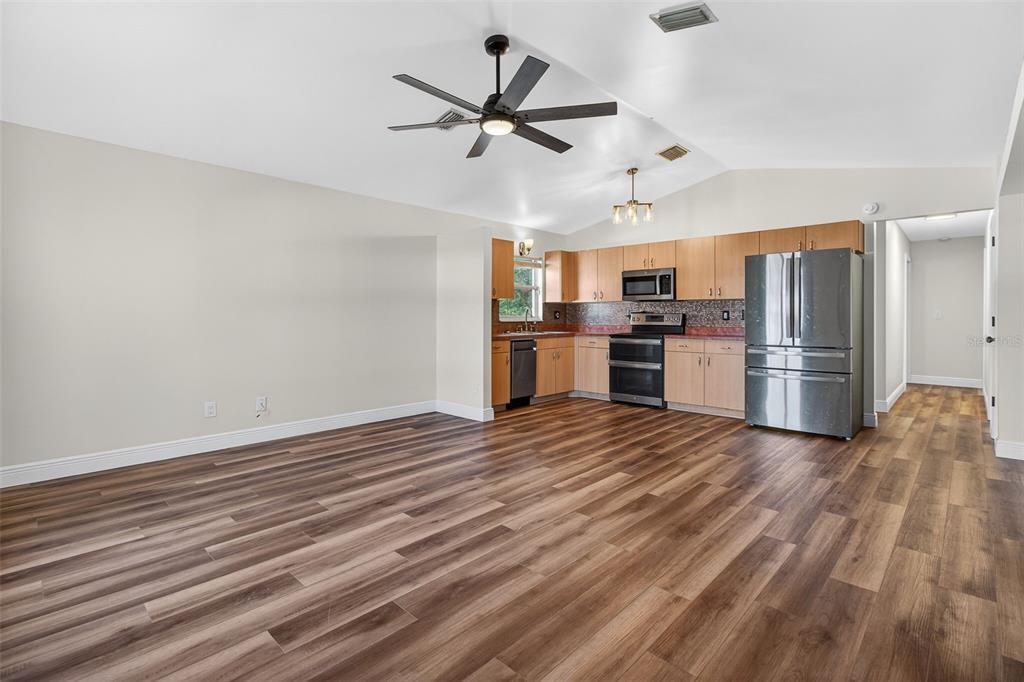2174 19th Avenue Southwest Largo, FL 33774 - Photo 3 of 31 a view of a kitchen with a stove cabinets and wooden floor