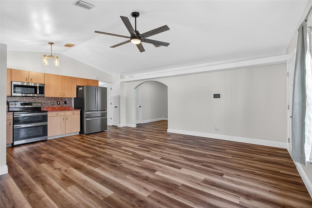 2174 19th Avenue Southwest Largo, FL 33774 - Photo 4 of 31 a view of a kitchen with wooden floor and a ceiling fan