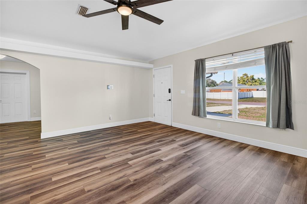 2174 19th Avenue Southwest Largo, FL 33774 - Photo 5 of 31 a view of an empty room with wooden floor and a window