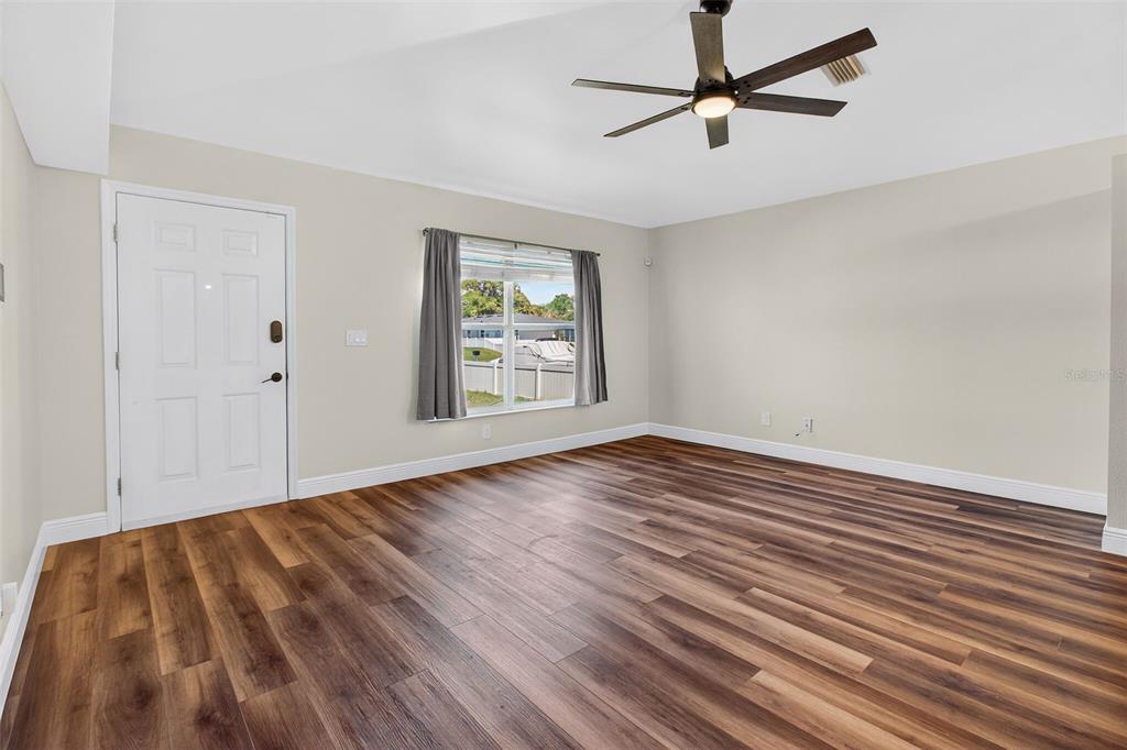 2174 19th Avenue Southwest Largo, FL 33774 - Photo 6 of 31 wooden floor in an empty room with a window