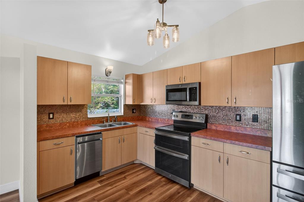 2174 19th Avenue Southwest Largo, FL 33774 - Photo 8 of 31 a kitchen with stainless steel appliances a sink stove microwave and refrigerator