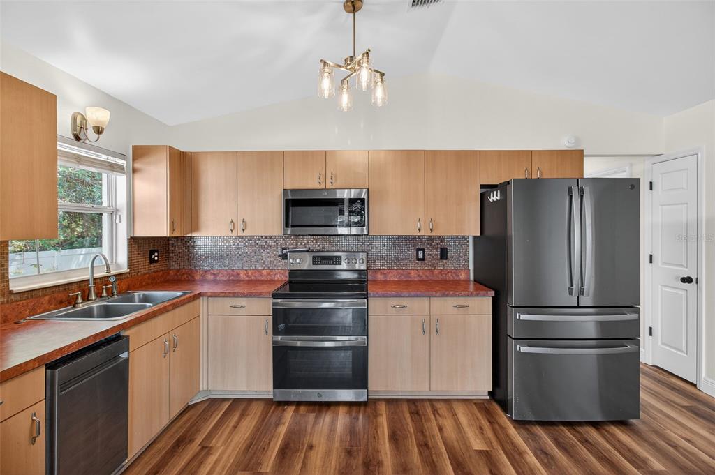 2174 19th Avenue Southwest Largo, FL 33774 - Photo 9 of 31 a kitchen with a refrigerator and a sink