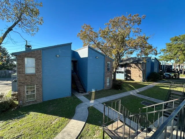 a view of a house with backyard porch and sitting area