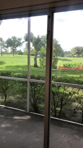 a view of a yard with a street from a window