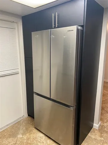 a white refrigerator freezer and a refrigerator in a kitchen