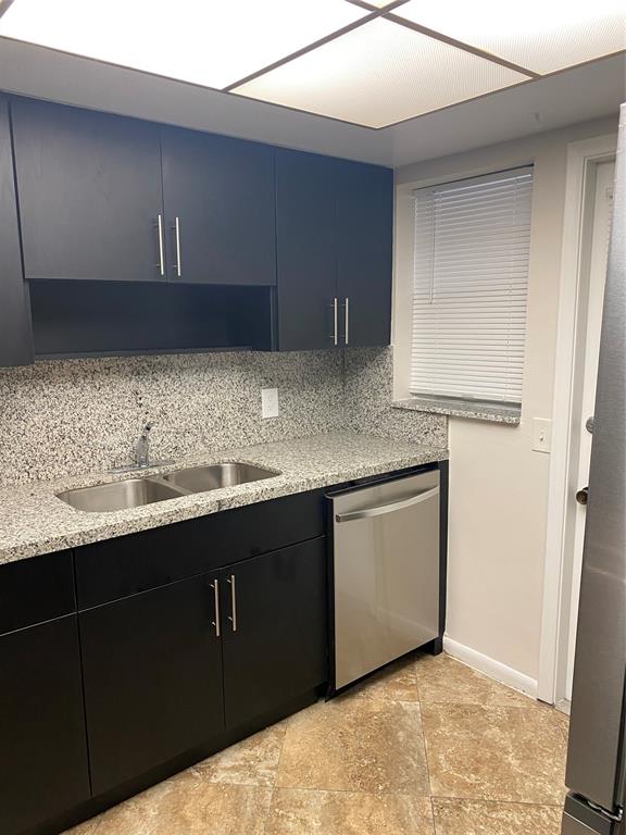 2481 Southwest 82nd Avenue, Unit 101 Davie, FL 33324 - Photo 3 of 14 a kitchen with granite countertop a sink a stove and cabinets