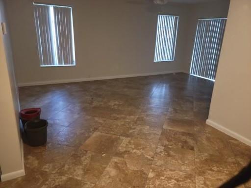 2481 Southwest 82nd Avenue, Unit 101 Davie, FL 33324 - Photo 6 of 14 an empty room with wooden floor and windows