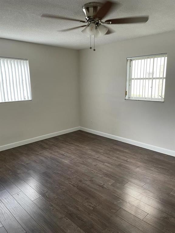 2481 Southwest 82nd Avenue, Unit 101 Davie, FL 33324 - Photo 9 of 14 wooden floor in an empty room with a window