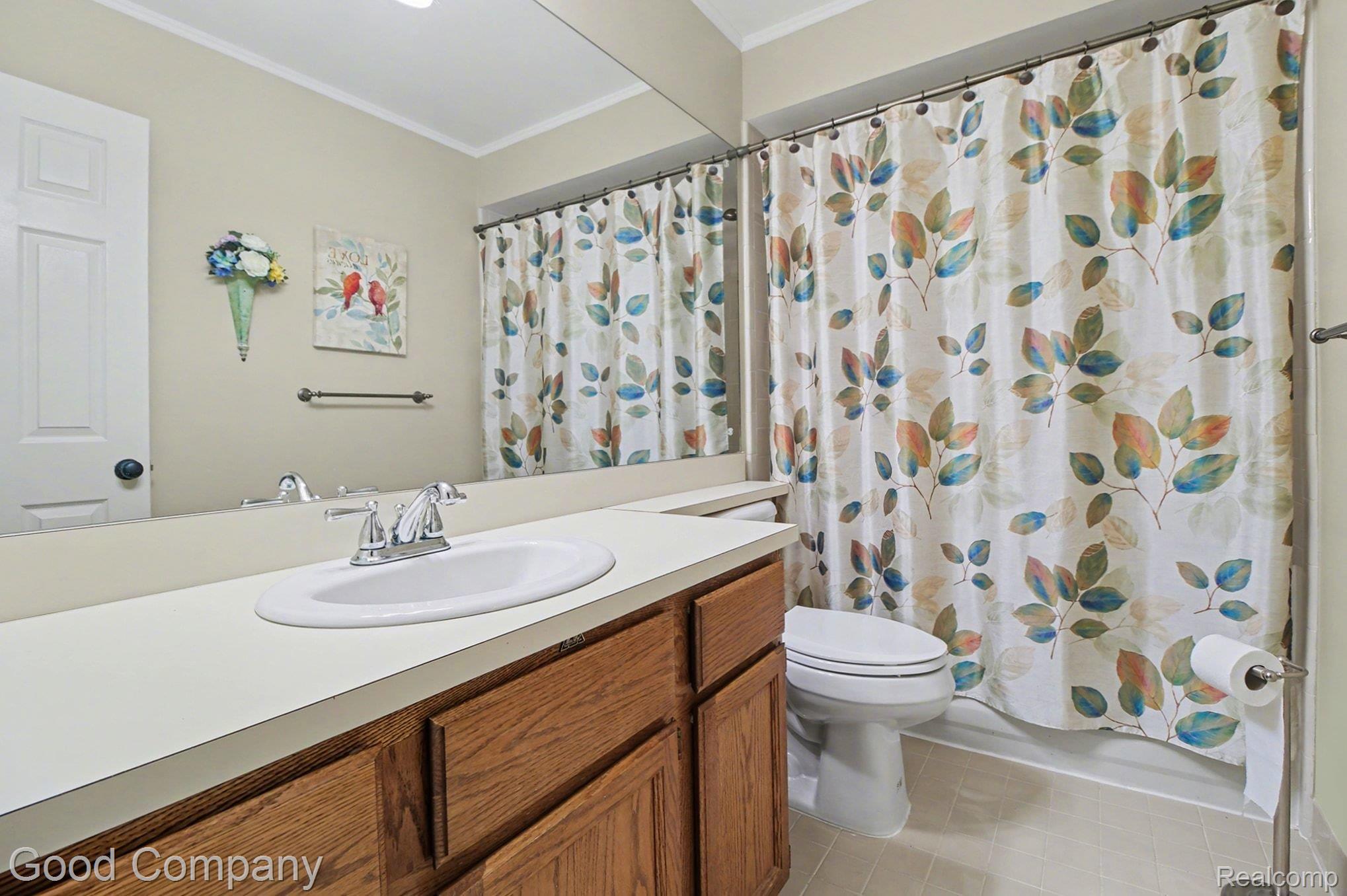 616 Tennyson Rochester, MI 48307 - Photo 8 of 20 Full bathroom featuring vanity, crown molding, shower / bath combo, and light tile patterned flooring