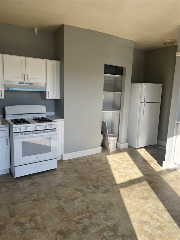 52 Mascot Street, Unit 6 Boston, MA 02124 - Photo 6 of 12 a kitchen with a stove and a refrigerator
