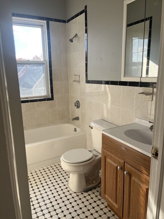 52 Mascot Street, Unit 6 Boston, MA 02124 - Photo 9 of 12 a bathroom with a sink toilet and shower