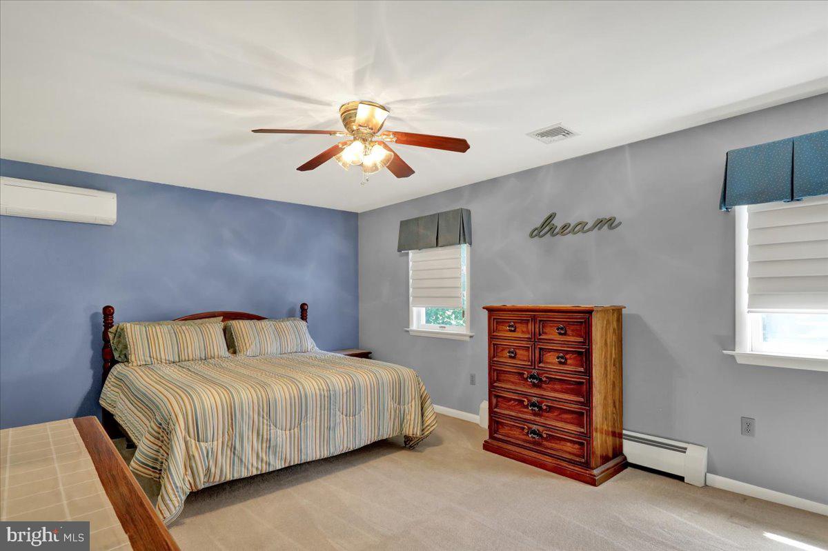 1649 Sherwood Road Reading, PA 19610 - Photo 12 of 37 a bedroom with a bed and a chandelier