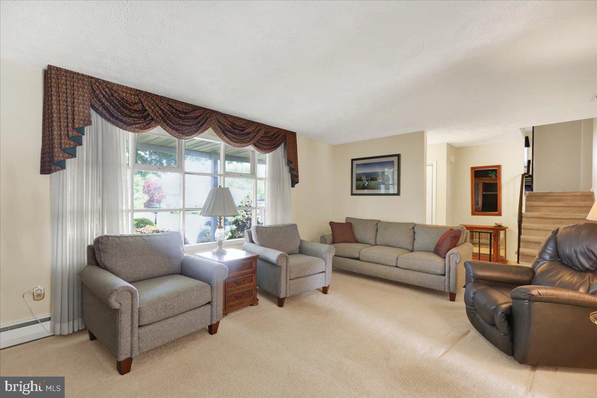 1649 Sherwood Road Reading, PA 19610 - Photo 2 of 37 a living room with furniture a large window and a flat screen tv