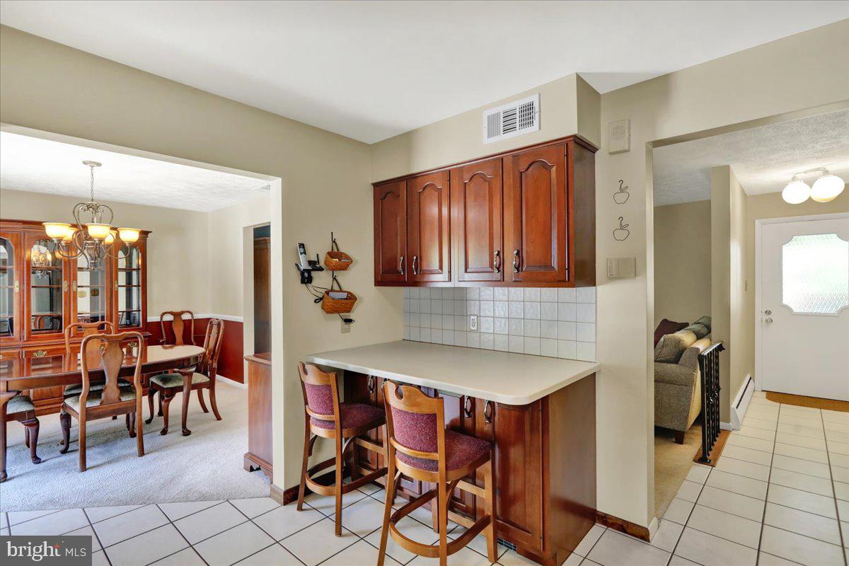 1649 Sherwood Road Reading, PA 19610 - Photo 9 of 37 a dining hall with a dining table and chairs