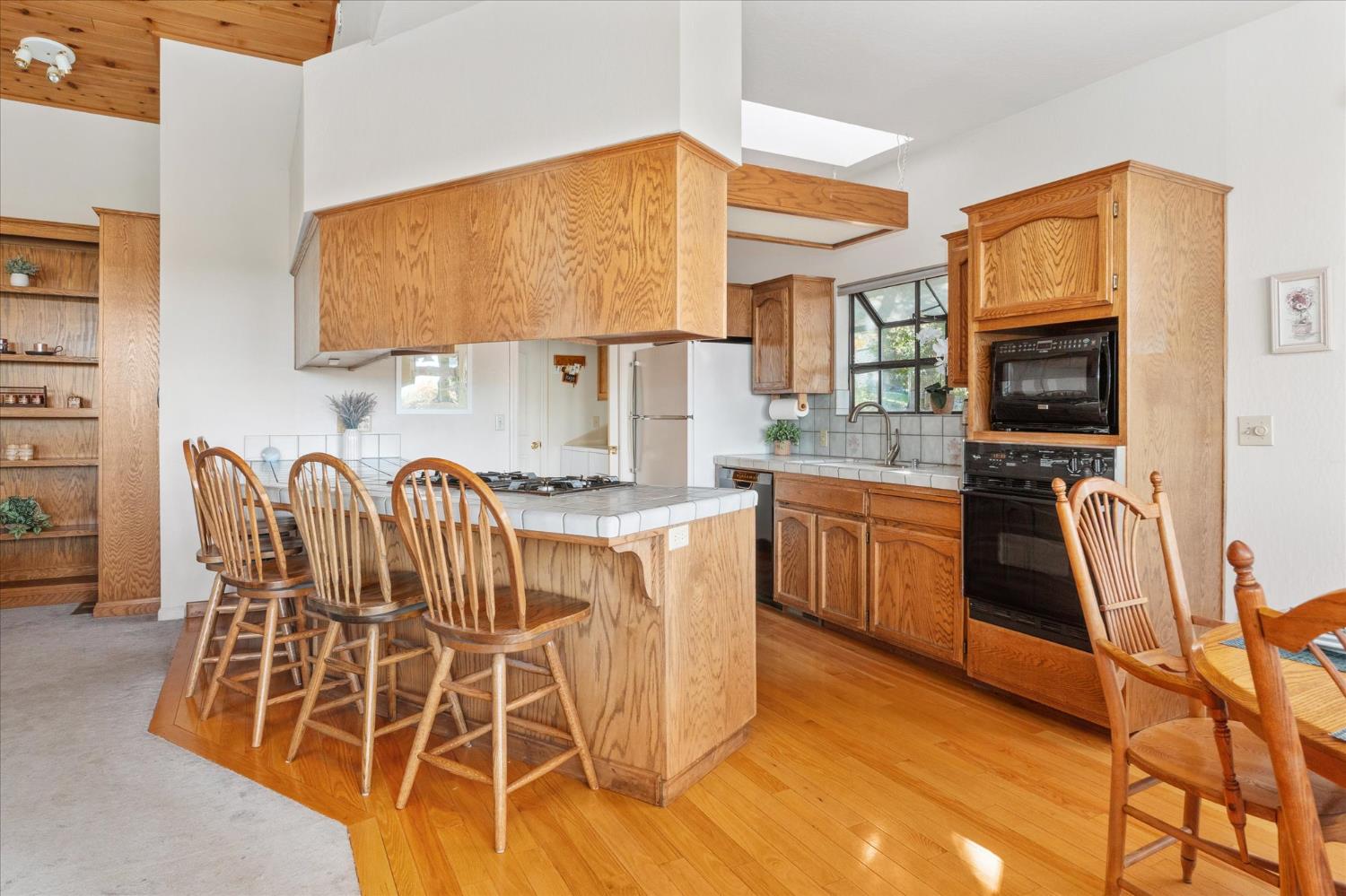 257 Snowberry Court Murphys, CA 95247 - Photo 15 of 56 a kitchen with stainless steel appliances kitchen island granite countertop a stove and a sink