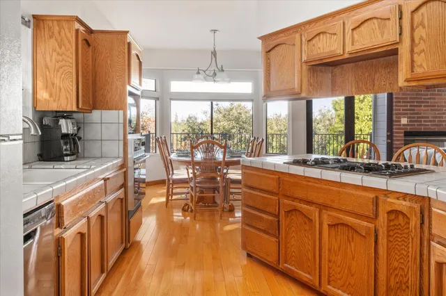 a roof deck with table and chairs and wooden floor