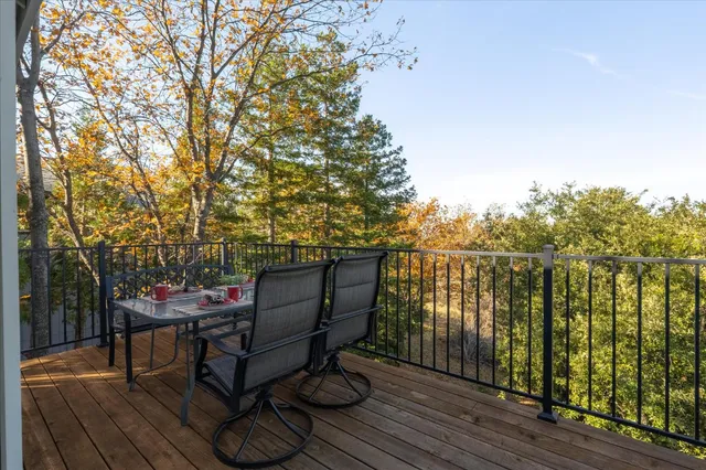 a view of a roof deck with wooden floor and fence
