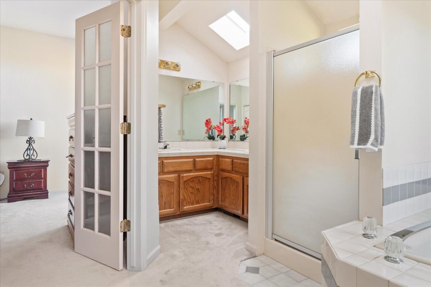 257 Snowberry Court Murphys, CA 95247 - Photo 26 of 56 a view of a bathroom with a sink and mirror