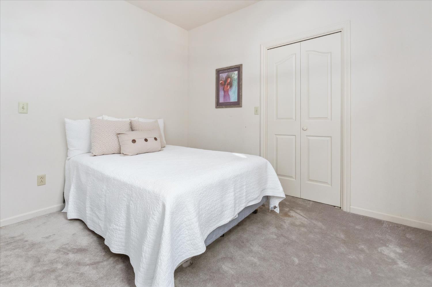 257 Snowberry Court Murphys, CA 95247 - Photo 29 of 56 a bed room with a bed and a night stand