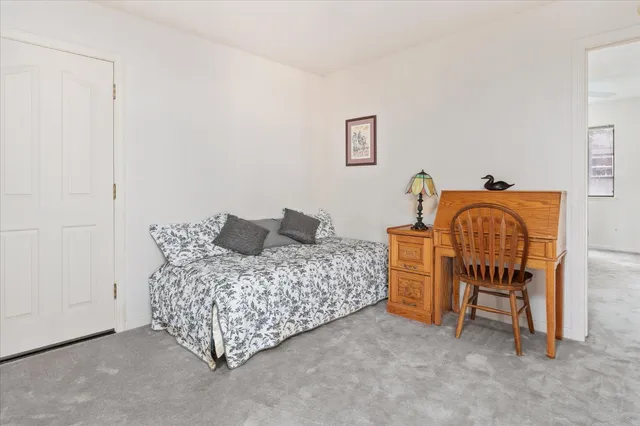 a bedroom with bed and window