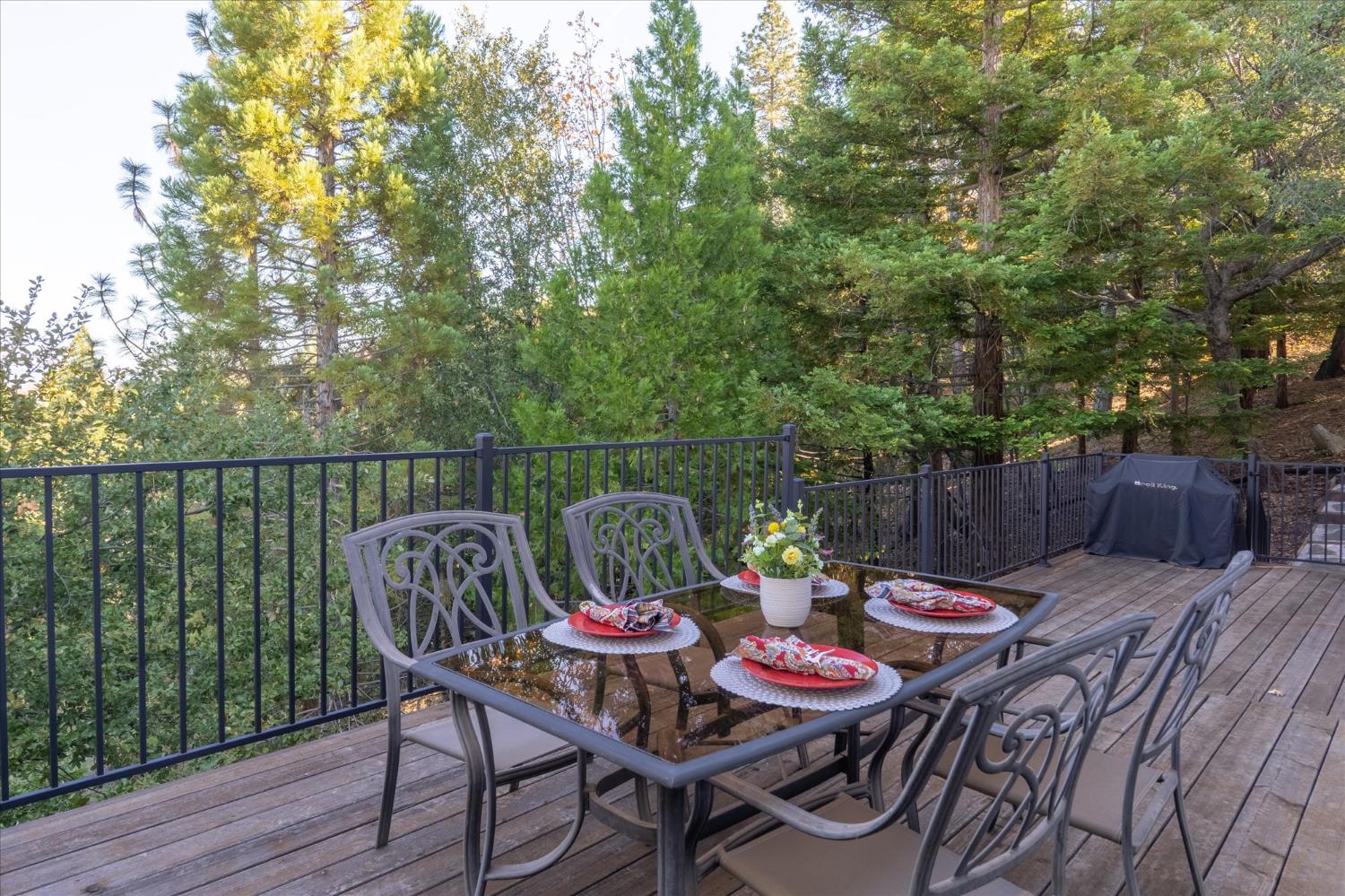 257 Snowberry Court Murphys, CA 95247 - Photo 42 of 56 a balcony with wooden floor table and chairs