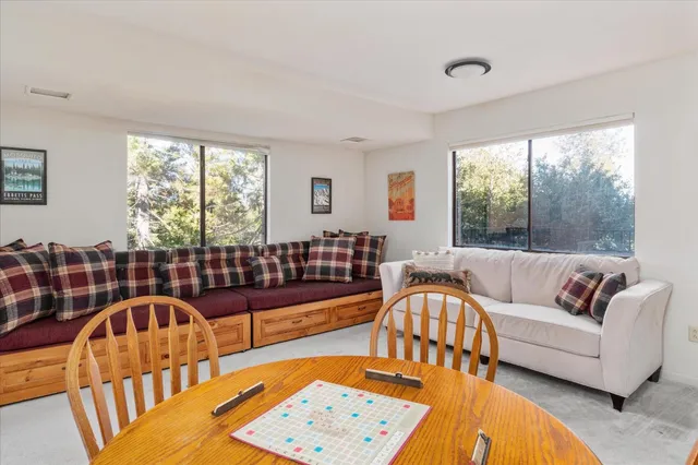 a living room with furniture and two window