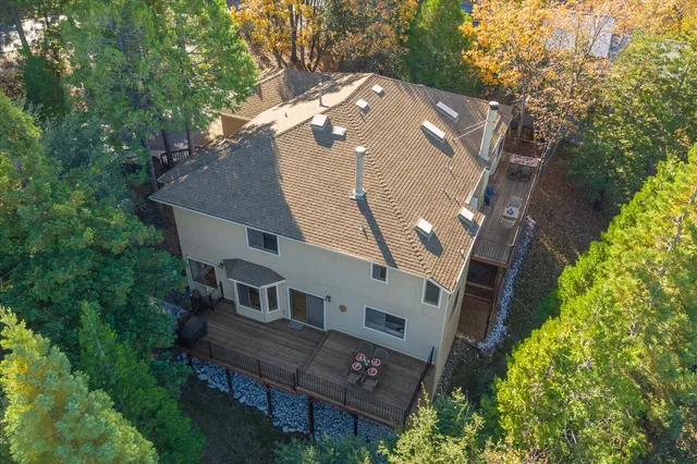 an aerial view of a house with a yard and potted plants