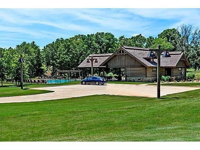 a view of a swimming pool with a lawn chairs and plants