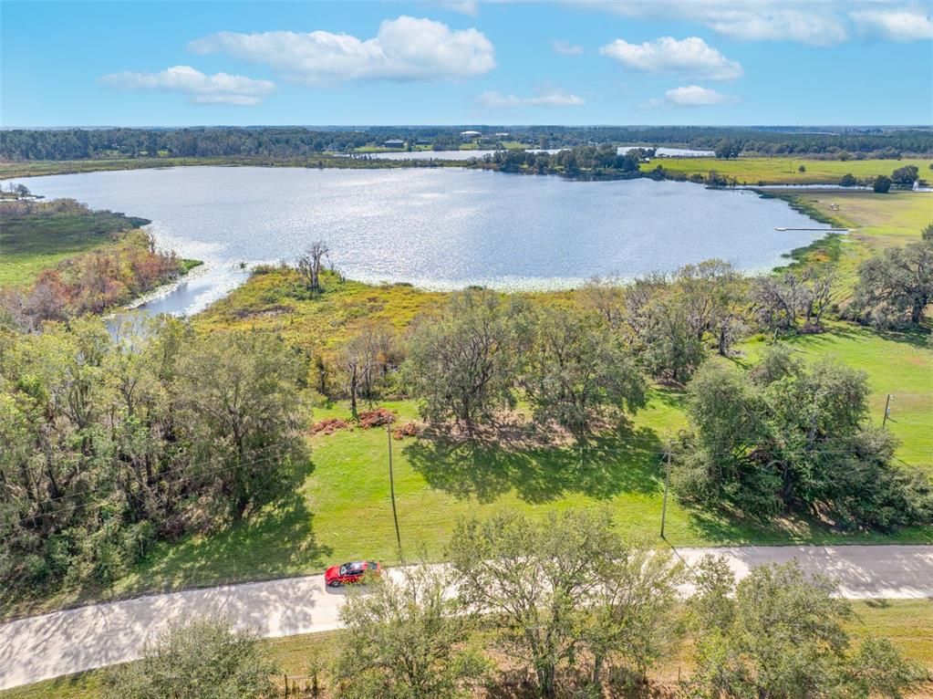 0 McKendree Road Wesley Chapel, FL 33545 - Photo 17 of 25 a view of a lake with houses in the back